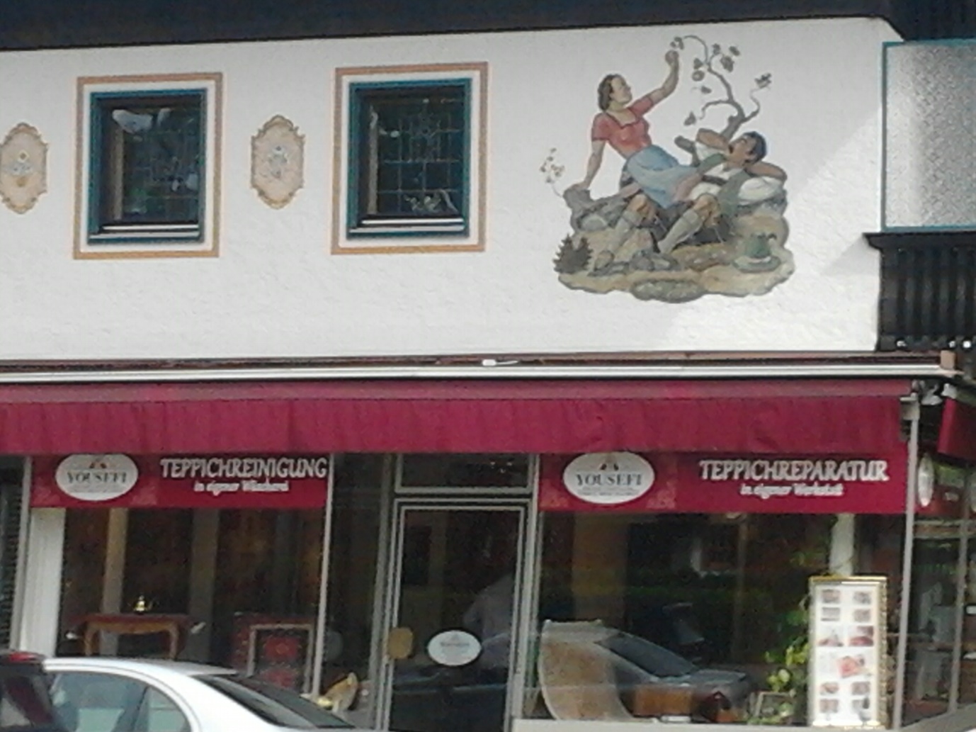 A typical Bavarian business premises. Note the beautiful artwork depicting daily life in the region, a feature of many buildings in Bavaria.